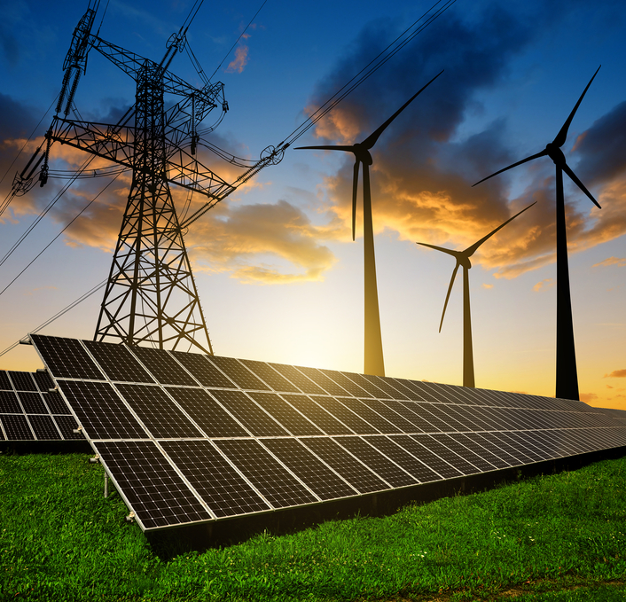 Solar panels with wind turbines and electricity pylon at sunset. Clean energy concept.